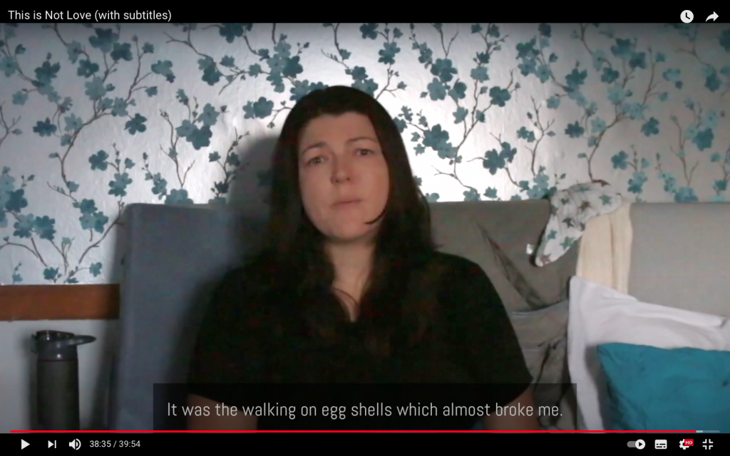 A female actor in a screenshot from the video This is Not Love. This woman's reaction is typical. The subtitle reads: 'It was the walking on egg shells which almost broke me'