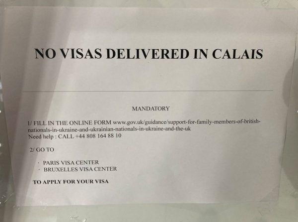 Sign reading "No visas delivered in Calais", seen on the main information noticeboard at Calais youth hostel where Ukraine refugees are sleeping.