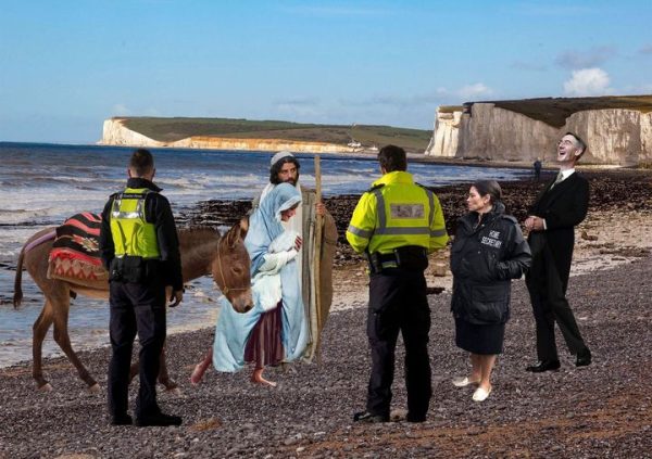 Police and immigrants on a beach