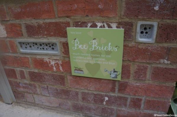 Brick wall with specially designed inserts with holes to provide homes for bees and other insects