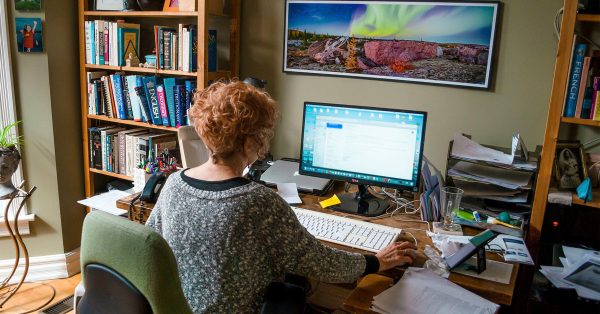 Woman at her computer working at home