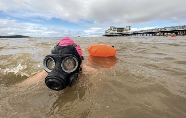 Swimmer using a mask and snorkel because of the sewage