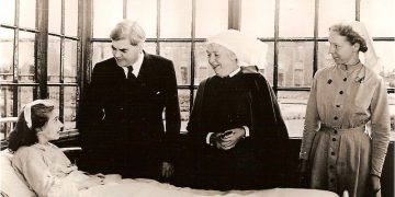 Photo dating from 1948 showing health minister Nye Bevan and two nurses beside the hospital bed of a young patient. It was taken to mark the birth of the NHS