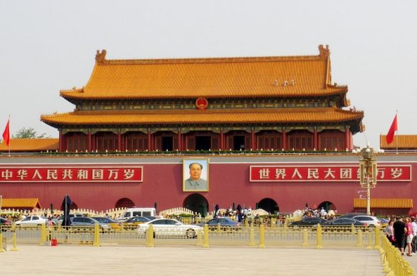 A large impressive Chinese building in Beijing, featuring on its outer wall, a portrait of former leader Chairman Mao