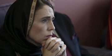 Jacinda Ardern looking throughtful wearing a headscarf
