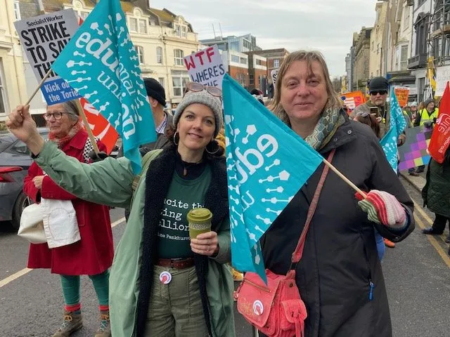 teachers with banners at a union solidarity rally in Hastings