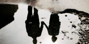 Reflection_of_man_&_woman_holding_hands