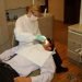 A dentist treats a patient in a dental surgery
