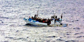 Boat at sea full of refugees