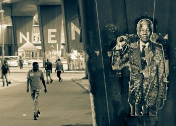 Street scene in Johannesburg with Nelson Mandela poster.