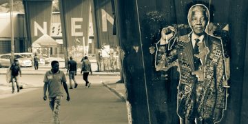 Street scene in Johannesburg with Nelson Mandela poster.