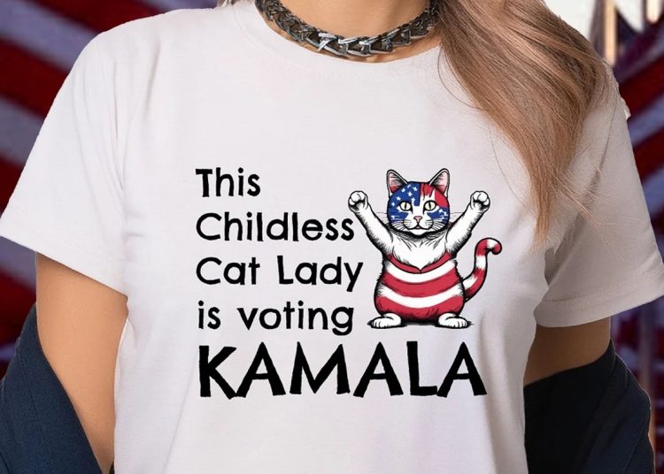 Woman wearing a T-shirt that says "This Childless Cat Lady is voting Kamala"