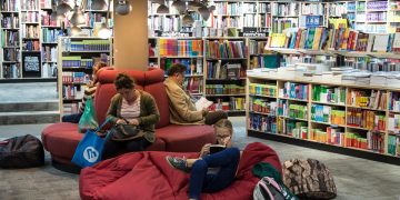 People relaxing in a library