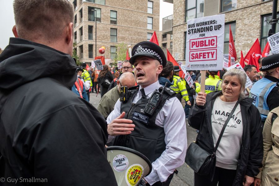 A demonstrator speaks with a police man