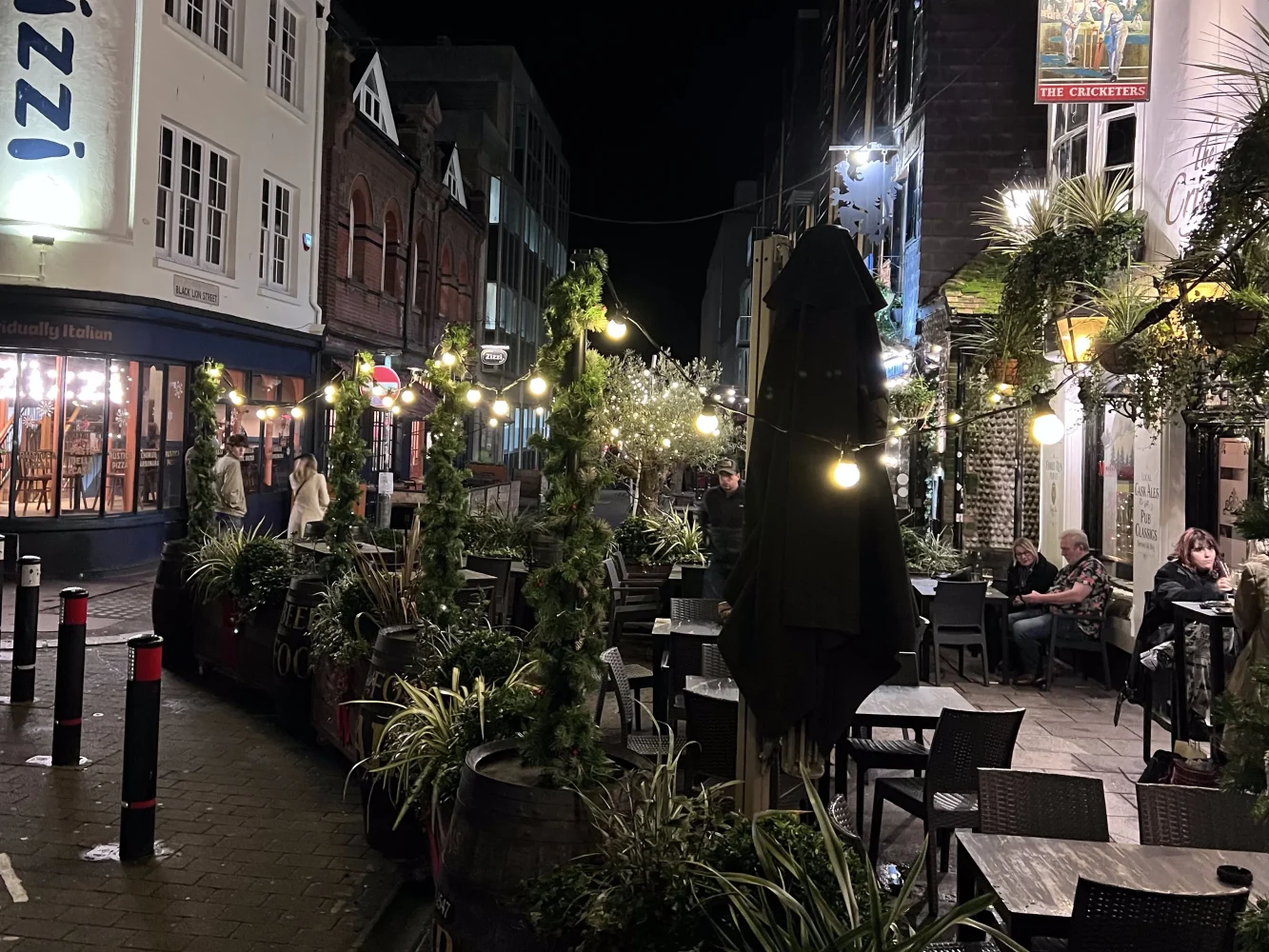 A nightime street in Brighton full of restaurants