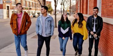 young people walking and talking and laughing