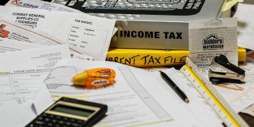 desk strewn with tax paraphernalia