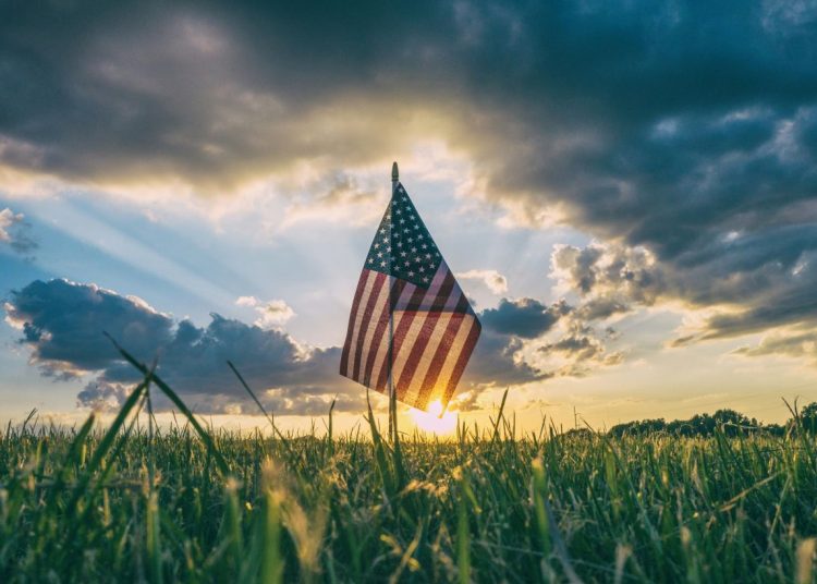 The American flag flying in a field
