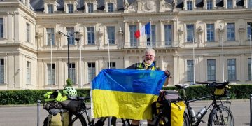Vic Ient with the Ukrainian flag and bicycle