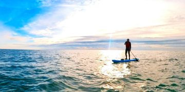 Jamie on his paddle board at sea.