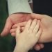Photo of Man, Woman and child's hands linked