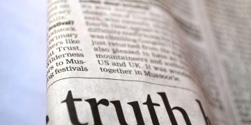 newspaper with the word truth in focus