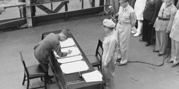 Gen. Yoshijiro Umezu, chief of the Japanese army’s general staff, signs the Instrument of Surrender on behalf of Japanese Imperial General Headquarters on the battleship USS Missouri, Sept. 2, 1945