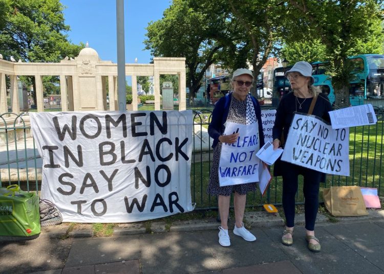 two women with placard No To War