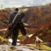 man carrying shotgun and dead birds