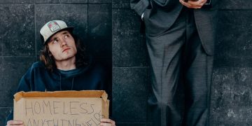 homeless man next to a businessman
