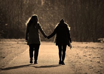 two women holding hands
