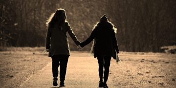 two women holding hands