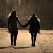 two women holding hands