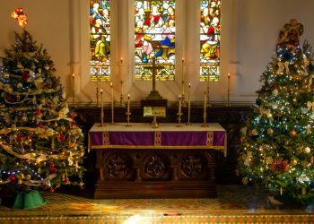 Church altar with Christmas trees either side