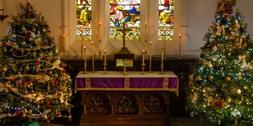 Church altar with Christmas trees either side
