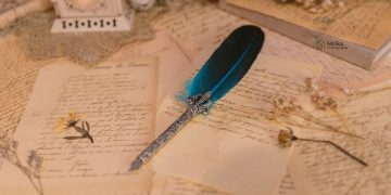 A quill on an old fashioned manuscript.