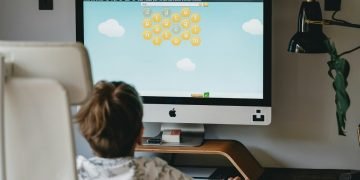 child playing game on computer screen