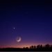 The night sky with stars and a partial moon