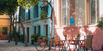 A table and chairs and a bike in a village in Spain