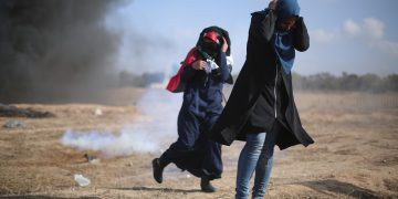 People running from an explosion in Gaza.