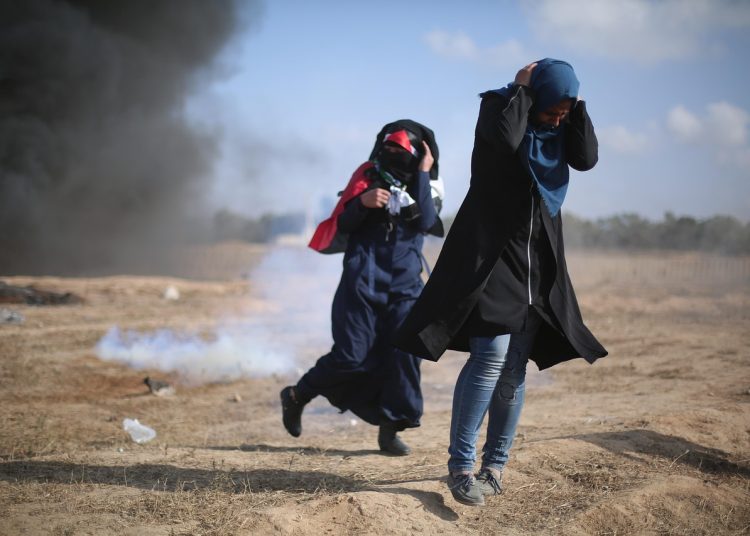 People running from an explosion in Gaza.