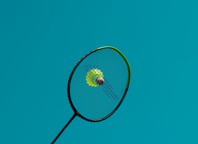 Badminton racket and shuttlecock.