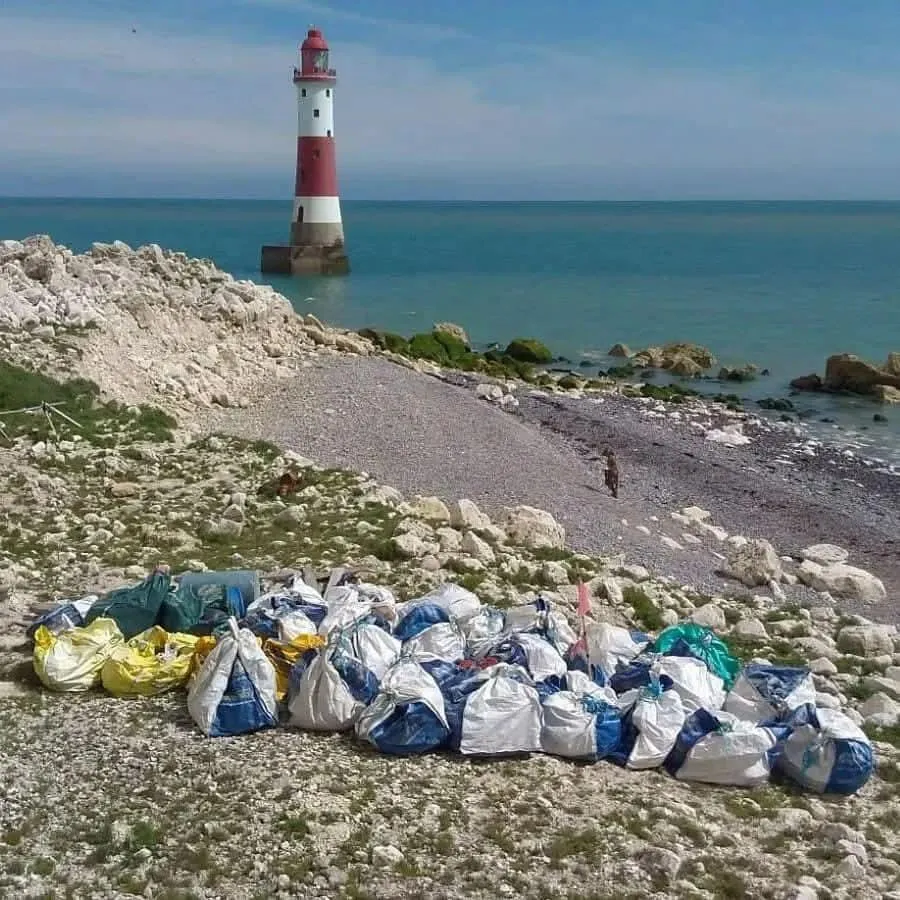Beachy Head Lighthouse and rubbish bags awaiting collection.