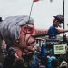 people protesting Brexit with image of Theresa May with an enormous nose with Brexit written on the side it spearing the UK