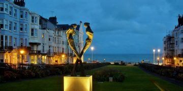 An image of Brighton's seafront, dimly lit under the night sky.