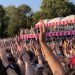 sea of hands and arms raised at a concert