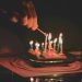 lighting candles on a birthday cake