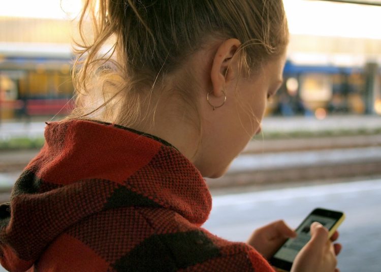 young woman holding mobile phone