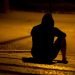 man sitting on the ground alone